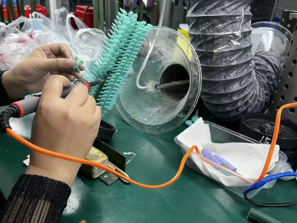 Custom Jewelry Quote: RFQ Template and Cost Comparison 3 Worker attaching green wax patterns to a sprue assembly