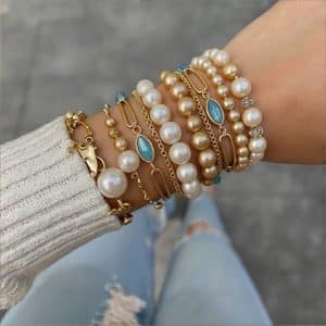 Close-up of vintage-style gold bangle with intricate engraved pattern