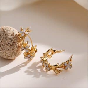 Gold earrings with star and moon celestial design featuring crystal details