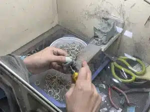 Hand finishing process in jewelry manufacturing