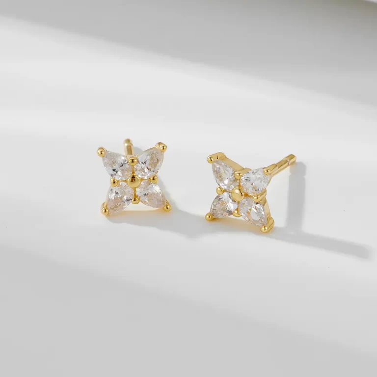 Gold bow stud earrings with pearl detail