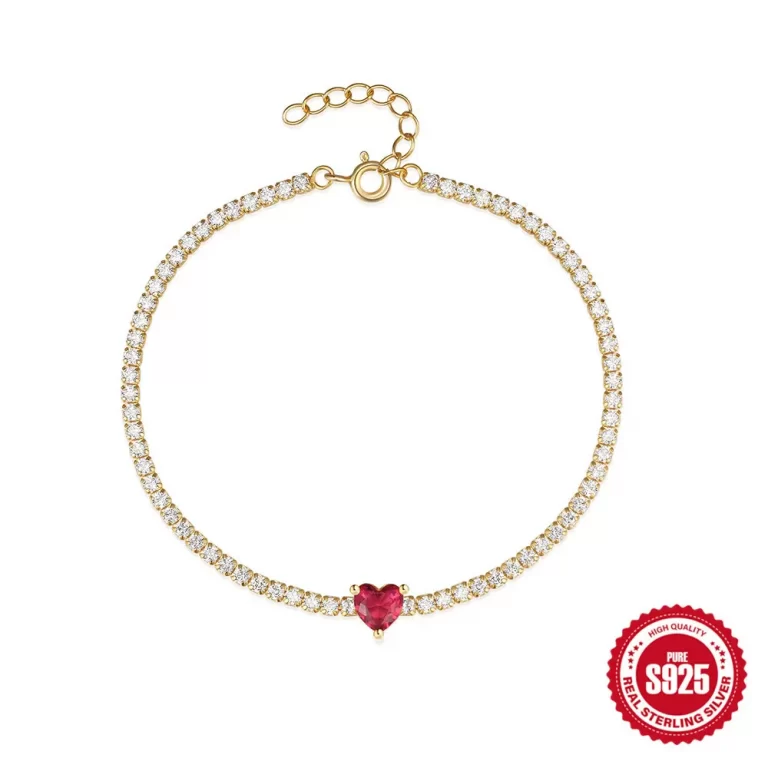 Gold chain bracelet with small red stone accent