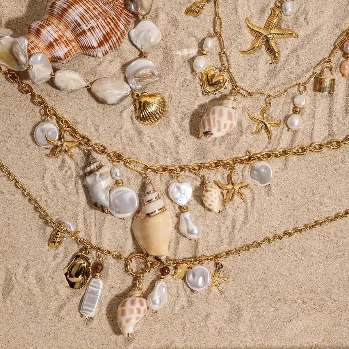 Detailed view of stainless steel necklace with butterfly and pearl pendants