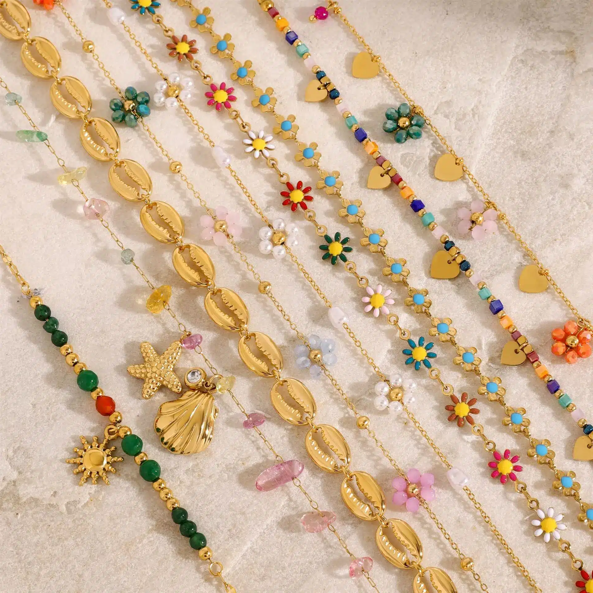 Close-up of gold plated stainless steel jewelry with crystal and pearl details