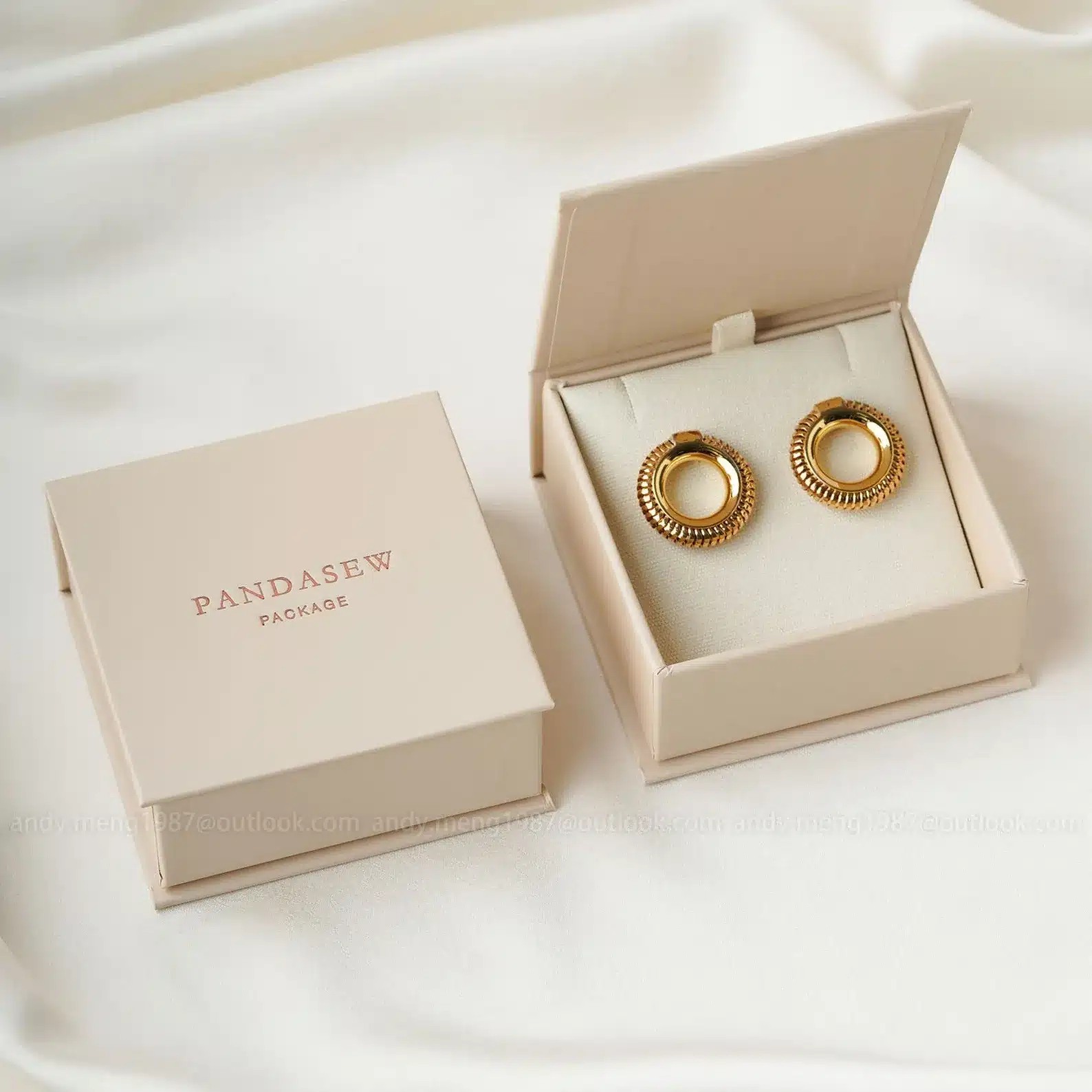 Beige box with gold earrings
