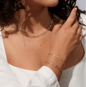 what is permanent jewelry welding process showing a delicate gold chain being secured on a wrist