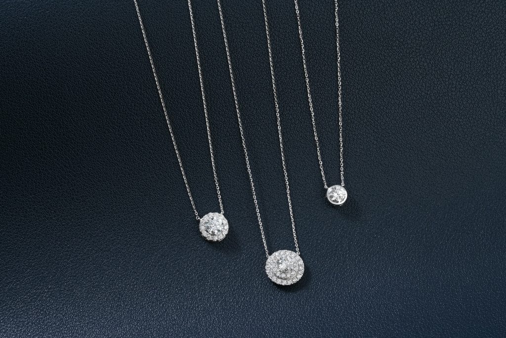 A group of three necklaces sitting on top of a table