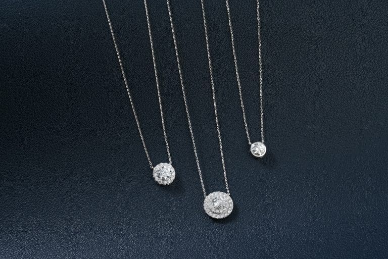How Long Does Sterling Silver Last? Tips for Longevity 3 A group of three necklaces sitting on top of a table