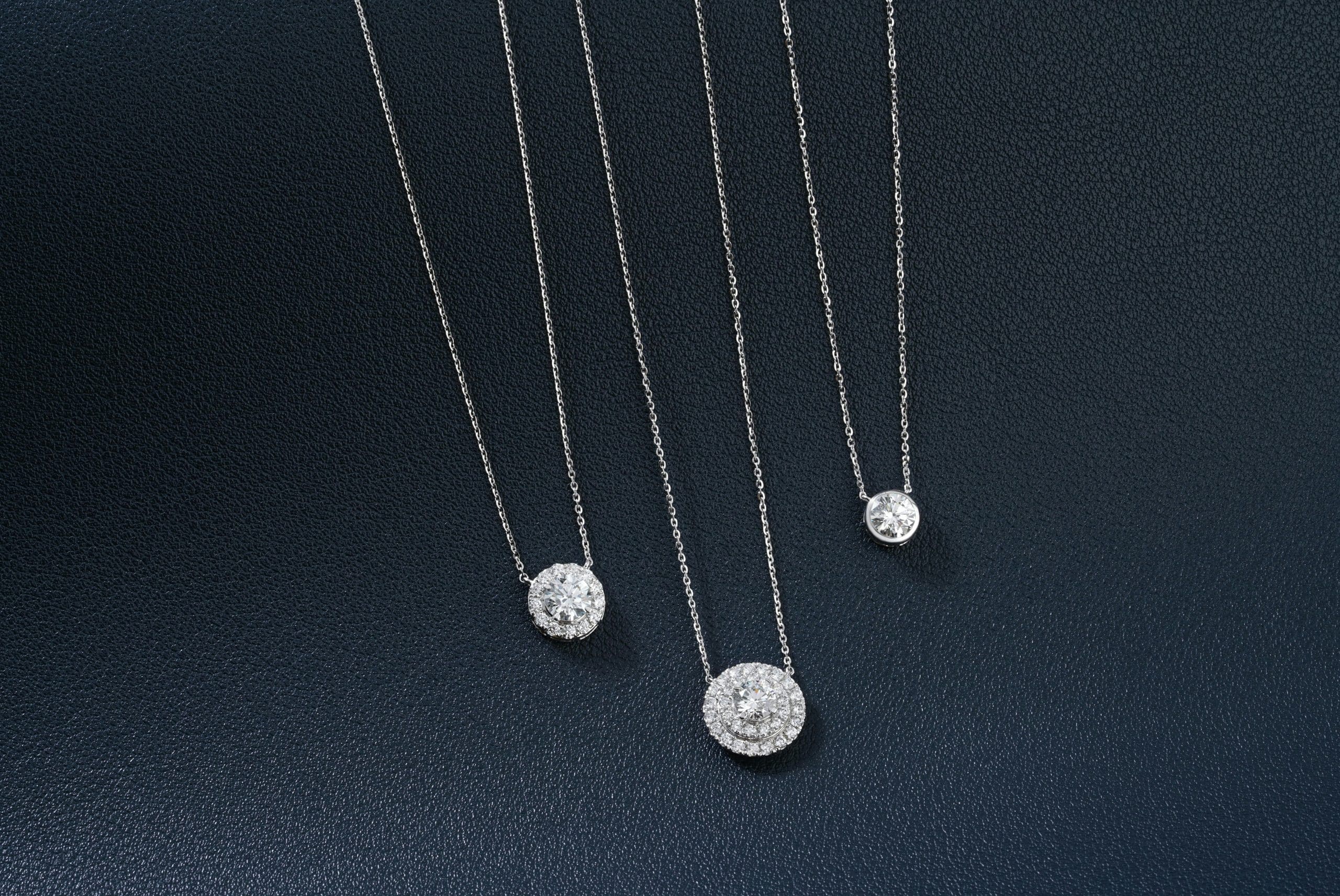 A group of three necklaces sitting on top of a table