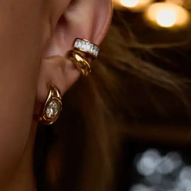 Stainless Steel Jewelry 15 Gold ear cuff and cubic zirconia huggie hoop earrings on ear - PVD Plated