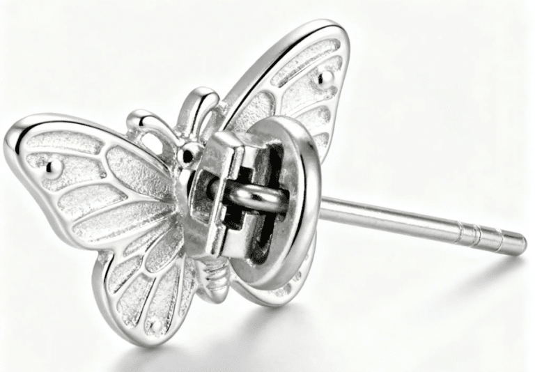 Close view of a decorative butterfly-shaped earring with its post and backing.
