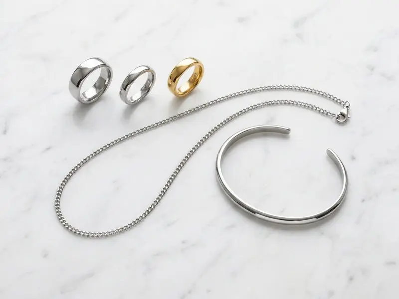 Home 49 Is Stainless Steel Good for Jewelry ? Collection of stainless steel jewelry including rings necklaces and bracelets in silver and gold finish