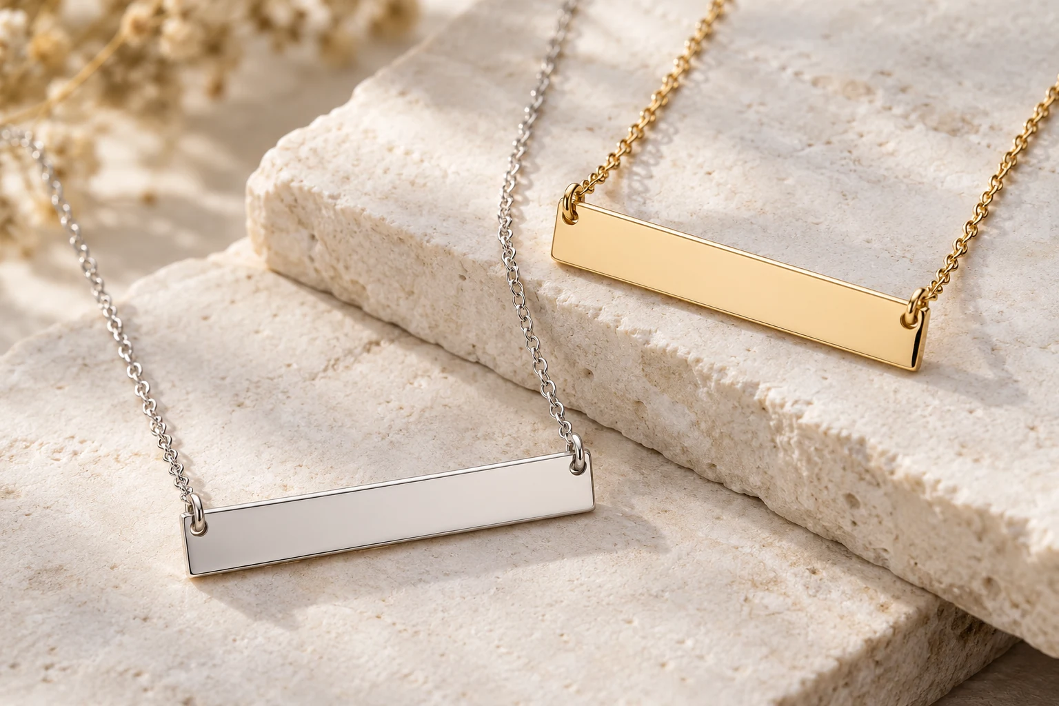 Silver-colored and gold-colored rectangular bar necklaces with plain surfaces for personalization.