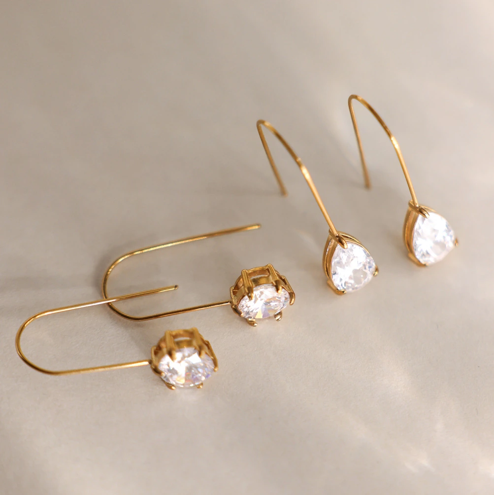 What Is Fine Jewelry? Metals, Stones and Quality Explained 3 Clear-stone drop earrings with the earwire and setting visible
